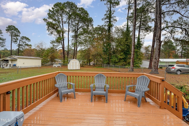 deck with a shed and a yard