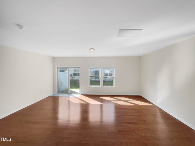 empty room with dark hardwood / wood-style floors