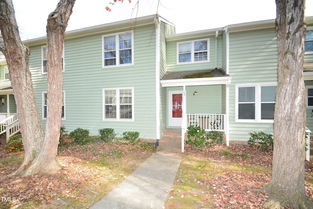 townhome / multi-family property featuring a porch