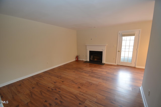 unfurnished living room featuring wood-type flooring