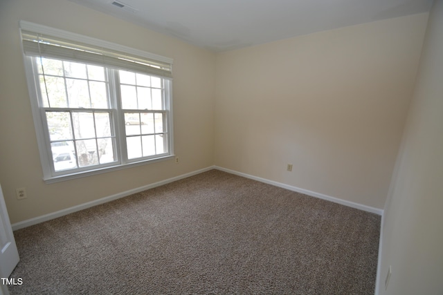 spare room featuring carpet floors