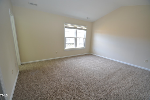 empty room with carpet and lofted ceiling