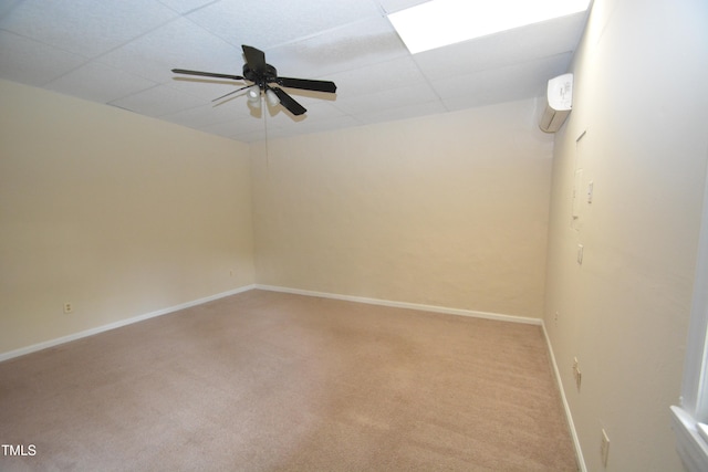 unfurnished room with a paneled ceiling, ceiling fan, and carpet