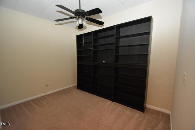 unfurnished bedroom with ceiling fan and carpet floors