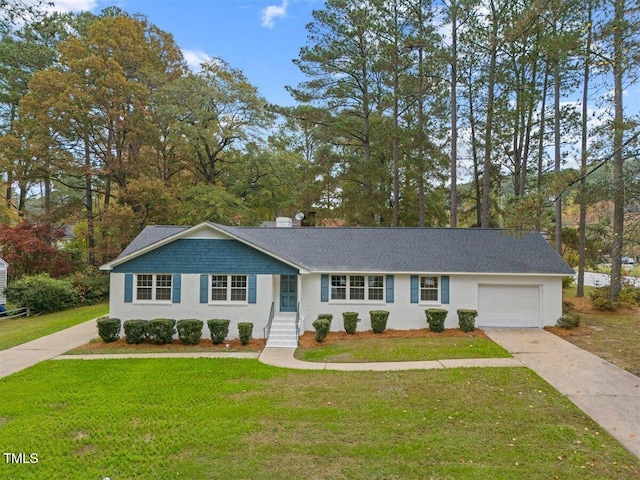 ranch-style house featuring a garage and a front lawn