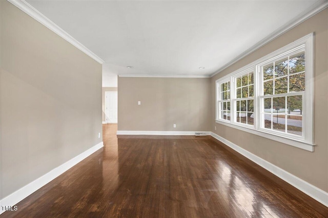 empty room with dark hardwood / wood-style floors and crown molding