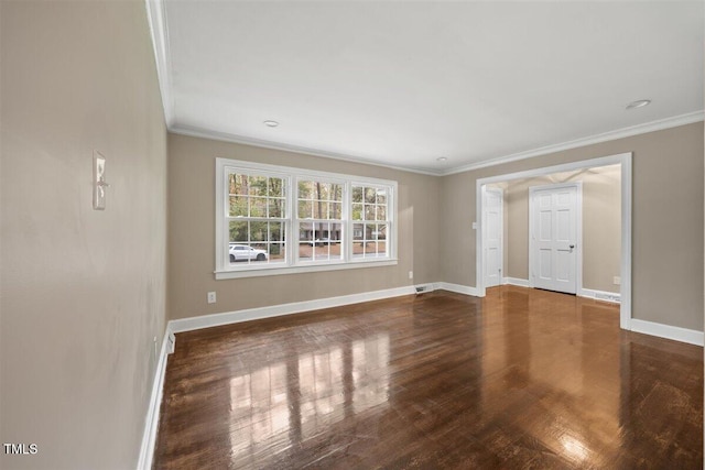 spare room with crown molding and dark wood-type flooring