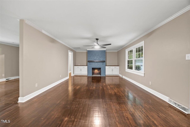 unfurnished living room with ceiling fan, ornamental molding, dark wood-type flooring, and a brick fireplace