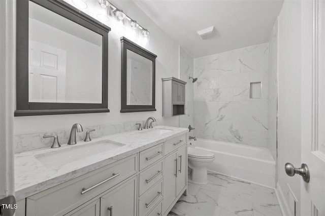 full bathroom featuring vanity, tiled shower / bath combo, and toilet