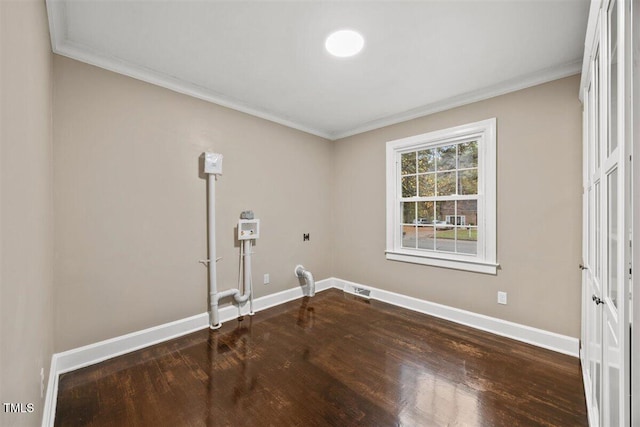 clothes washing area featuring crown molding and hardwood / wood-style flooring