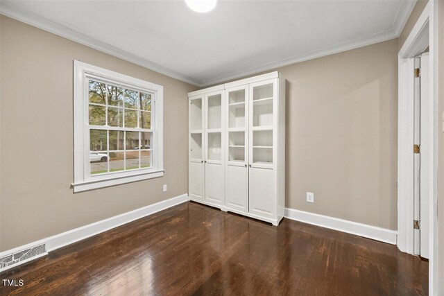 interior space featuring dark hardwood / wood-style floors and crown molding