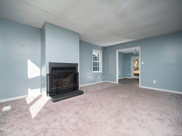 unfurnished living room featuring a textured ceiling and carpet floors