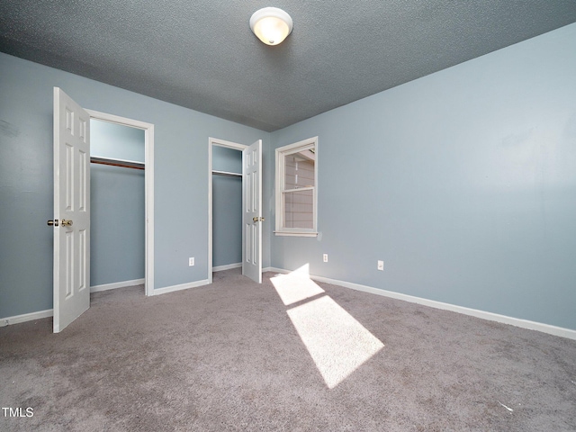 unfurnished bedroom with carpet floors and a textured ceiling