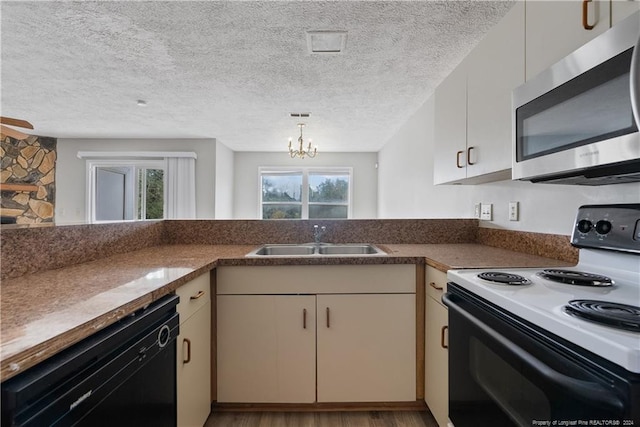 kitchen featuring sink, white electric range oven, an inviting chandelier, black dishwasher, and a textured ceiling