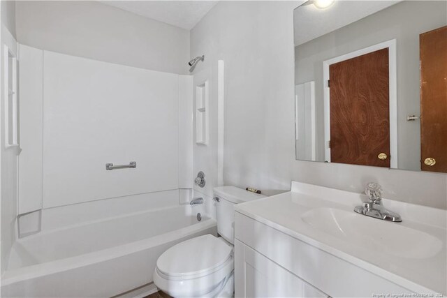 full bathroom featuring vanity,  shower combination, and toilet