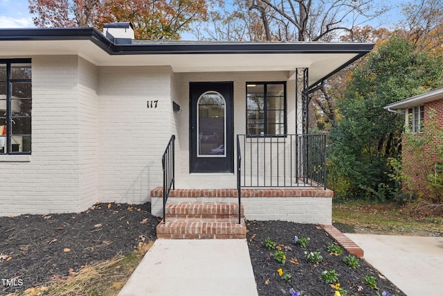 view of exterior entry with covered porch