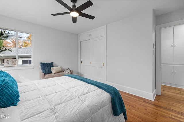 bedroom featuring hardwood / wood-style floors, ceiling fan, and a closet