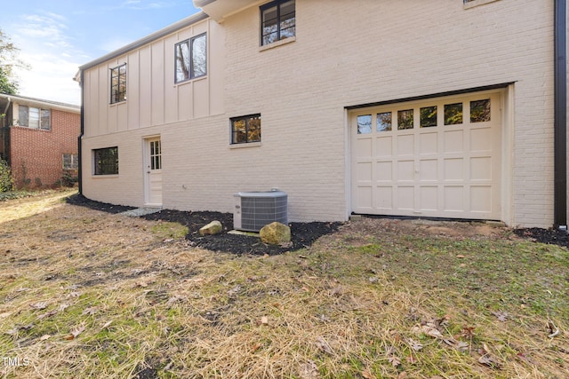 view of home's exterior with a garage and central AC