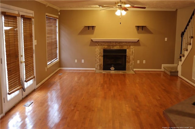 unfurnished living room featuring crown molding, plenty of natural light, ceiling fan, and hardwood / wood-style floors