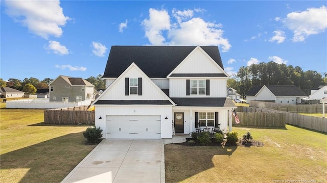 modern farmhouse featuring covered porch, a garage, and a front lawn