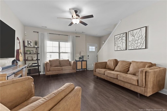 living room featuring dark hardwood / wood-style floors and ceiling fan