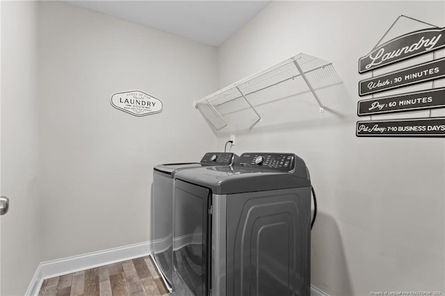 washroom featuring hardwood / wood-style flooring and independent washer and dryer