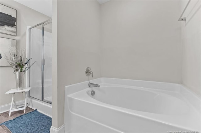 bathroom with wood-type flooring and independent shower and bath