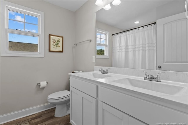 bathroom with vanity, hardwood / wood-style flooring, toilet, and plenty of natural light