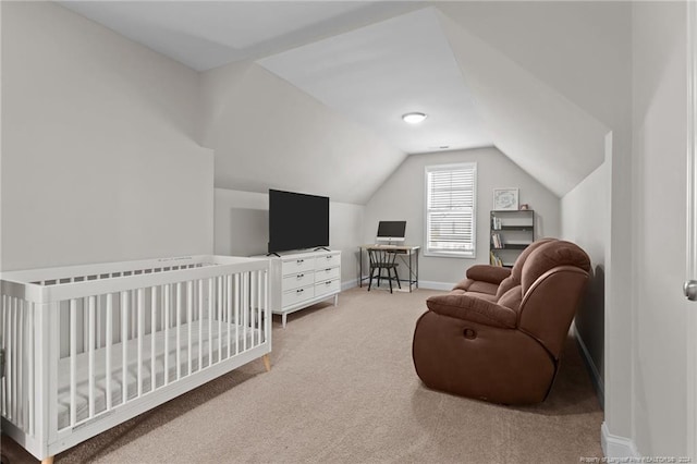 bedroom with lofted ceiling, carpet, and a crib