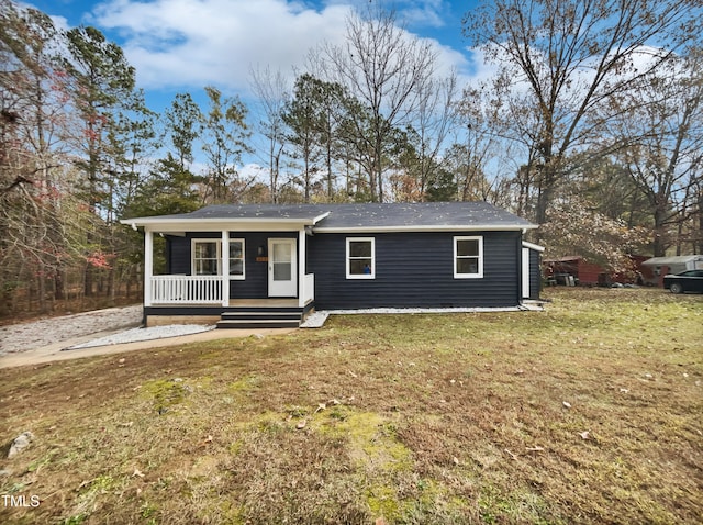 single story home with covered porch and a front yard