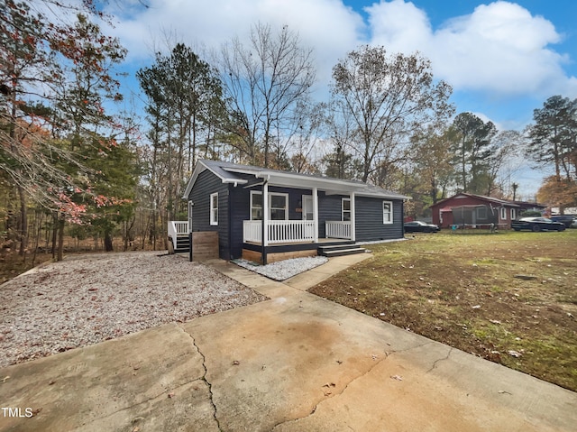 view of front of home featuring covered porch and a front yard