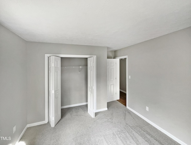 615 Wildaro Ct, Hillsborough, NC 27278 - unfurnished bedroom with baseboards, carpet flooring, and a closet