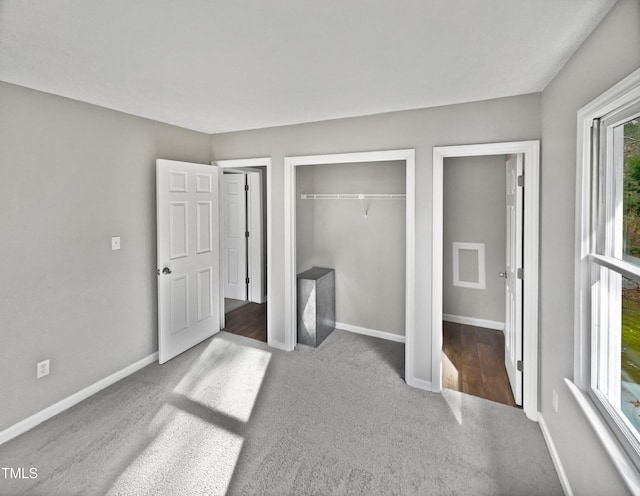 unfurnished bedroom with hardwood / wood-style flooring and a closet