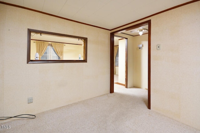 unfurnished room featuring carpet floors and crown molding