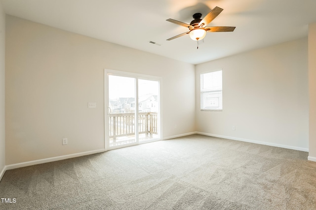 carpeted spare room featuring ceiling fan