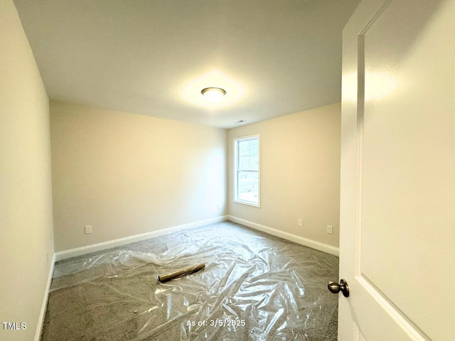 empty room featuring baseboards