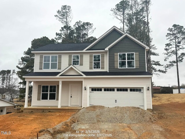 view of front facade with a garage, driveway, and a porch