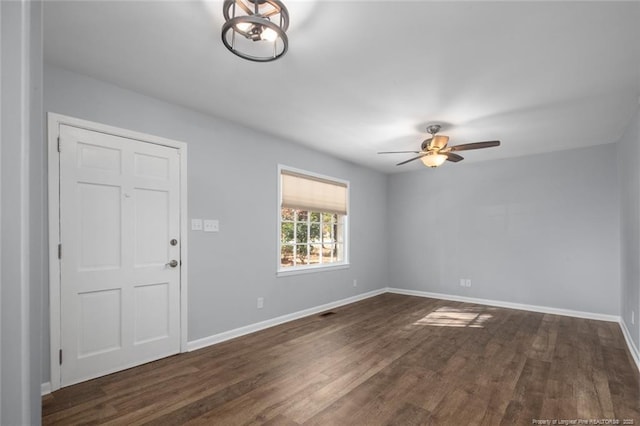 interior space with dark wood-type flooring, baseboards, and a ceiling fan