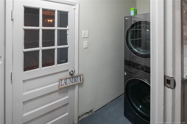 laundry area with stacked washer / dryer and laundry area