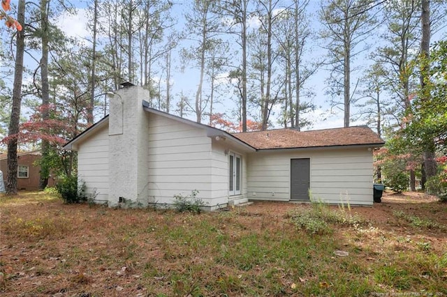 back of property featuring a chimney