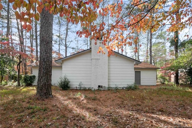 view of side of property featuring a chimney