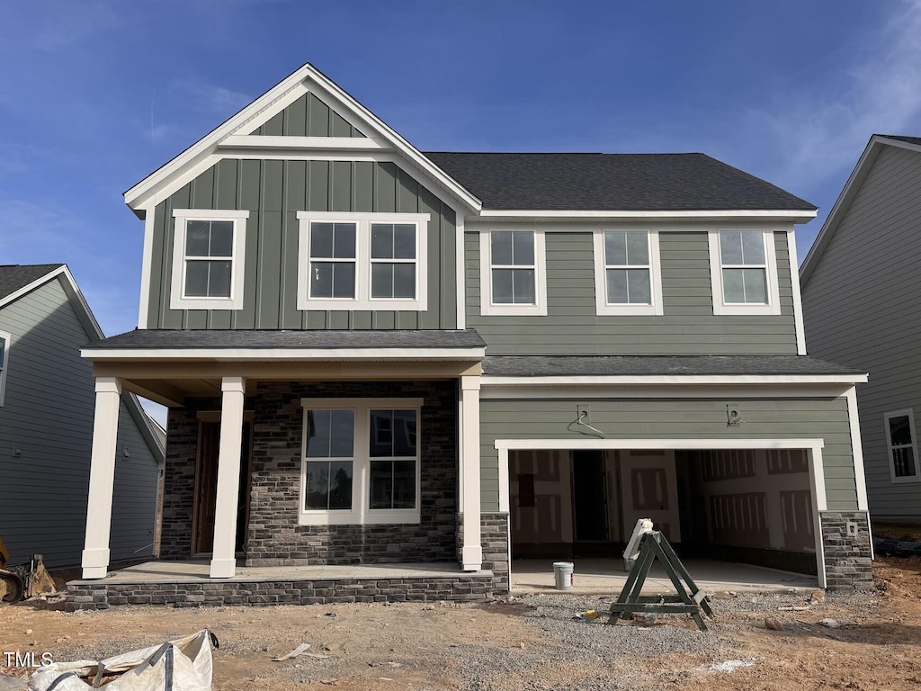 view of front of property featuring covered porch and a garage