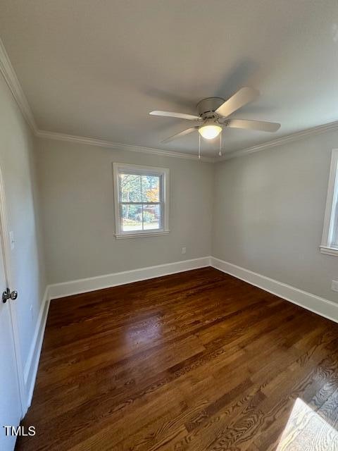 empty room featuring dark hardwood / wood-style floors, ceiling fan, and ornamental molding