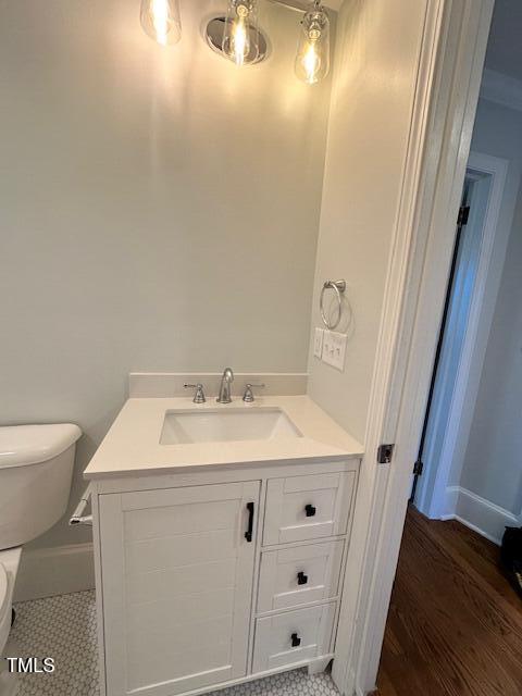 445 N Dunn St, Angier, NC 27501 - half bathroom featuring toilet, vanity, and baseboards