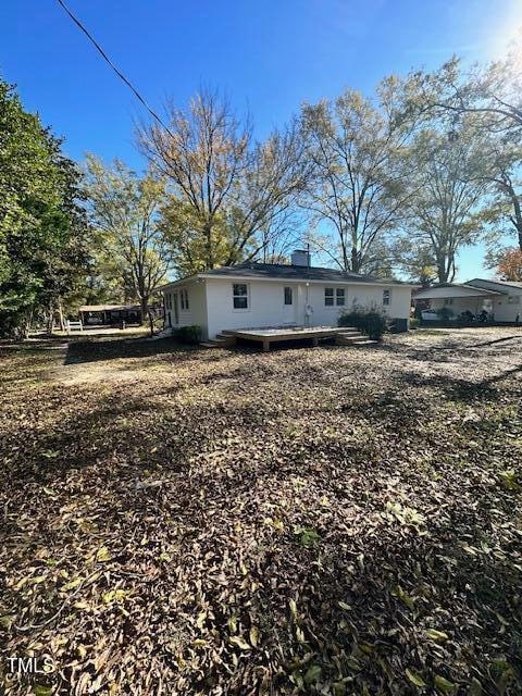 back of house with a deck