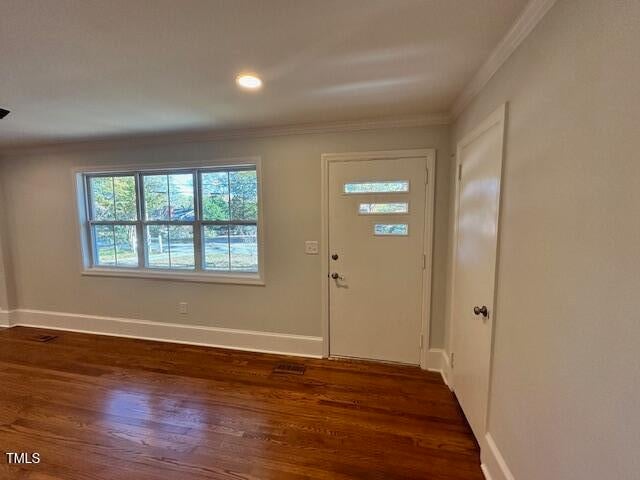 foyer with dark hardwood / wood-style floors and ornamental molding