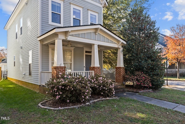 craftsman house with a front yard and a porch