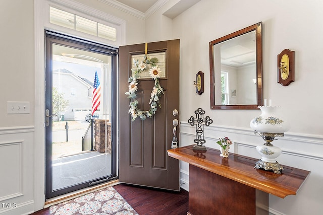 entryway with dark hardwood / wood-style flooring and crown molding