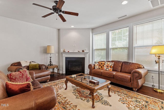 living room with wood-type flooring and ceiling fan