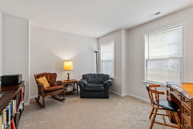 sitting room with light carpet and a healthy amount of sunlight